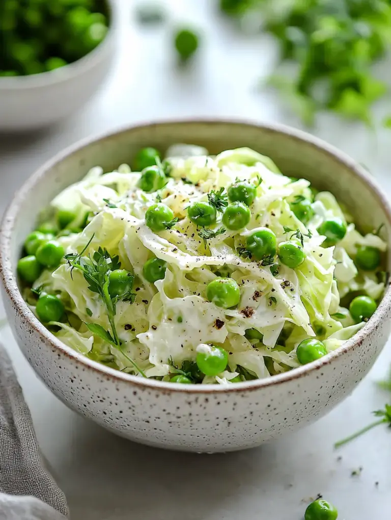 A rustic ceramic bowl filled with creamy cabbage and green pea salad, garnished with fresh herbs and cracked black pepper, styled on a light surface with scattered peas and herbs in the background.